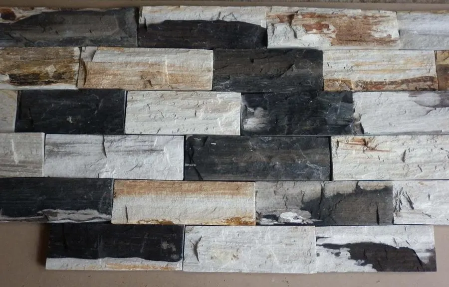 Stacked stone wall tiles in grey, white and brown tones