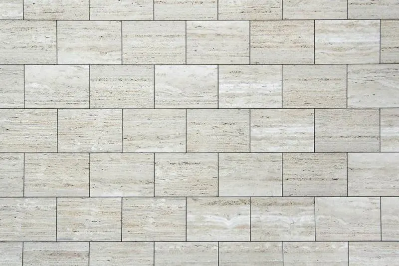Pale rectangular stone wall tiles laid in staggered courses