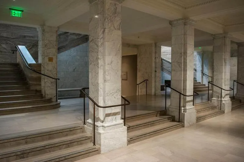 Interior staircase with pale marble steps and columns