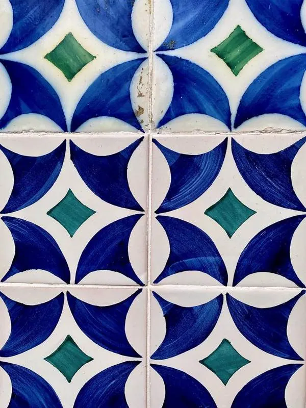 Blue, green and white ceramic tiles with a repeating floral motif