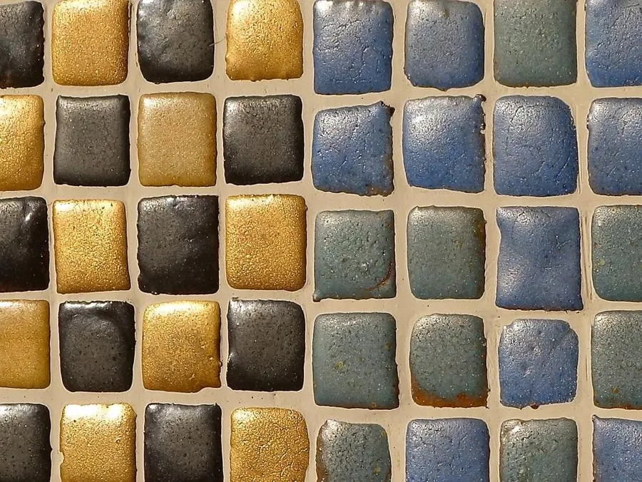 Small square mosaic tiles in blue, beige and dark brown
