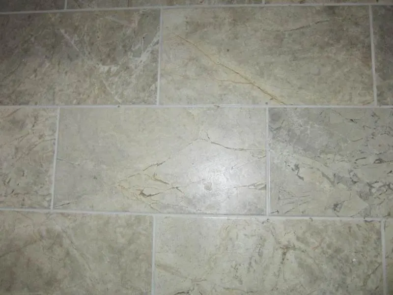 Large beige stone-pattern wall tiles with light grout joints