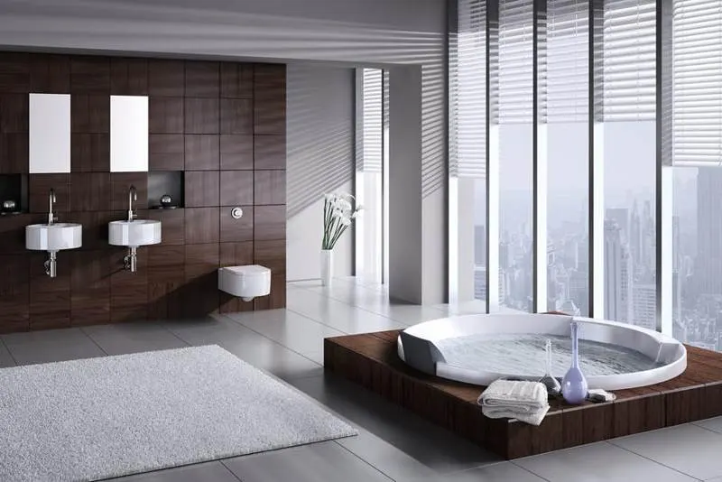 Bathroom with a recessed bathtub and large neutral wall tiles