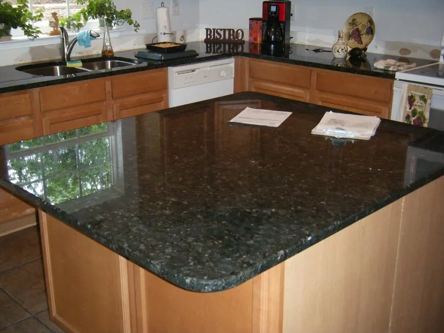 Dark polished granite kitchen island and counters