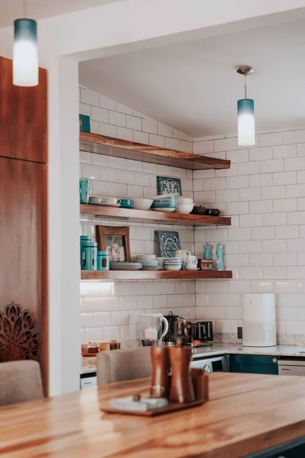 Kitchen with a white tiled backsplash and wooden counter