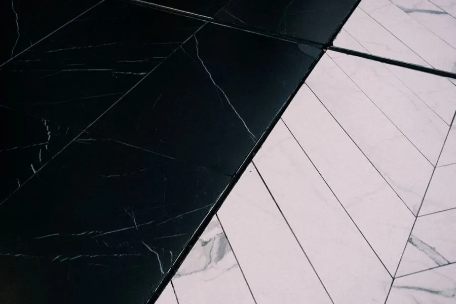 Black and white stone floor laid in contrasting geometric sections