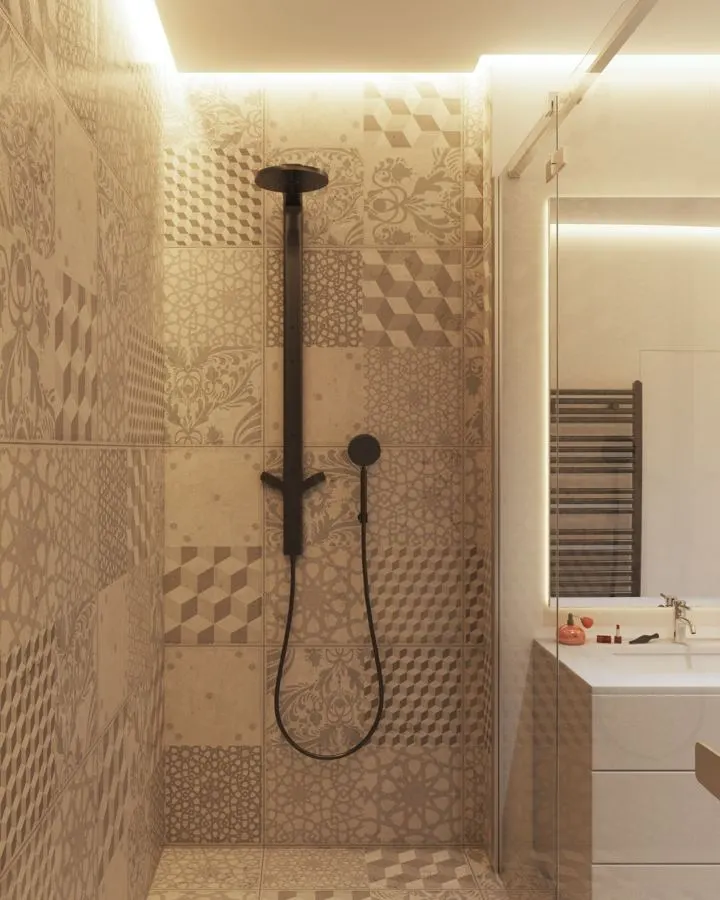 Shower with small beige mosaic tiles and a black shower fitting