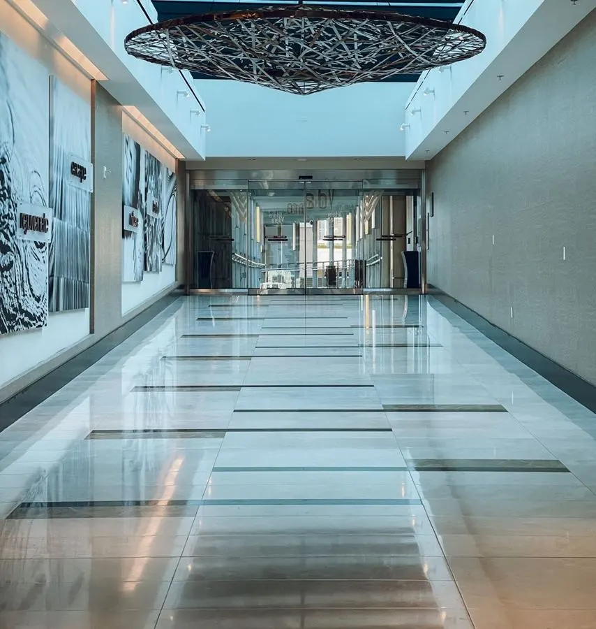 Polished pale stone corridor with dark linear borders
