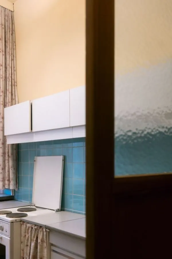 Kitchen window detail above a counter and tiled splashback