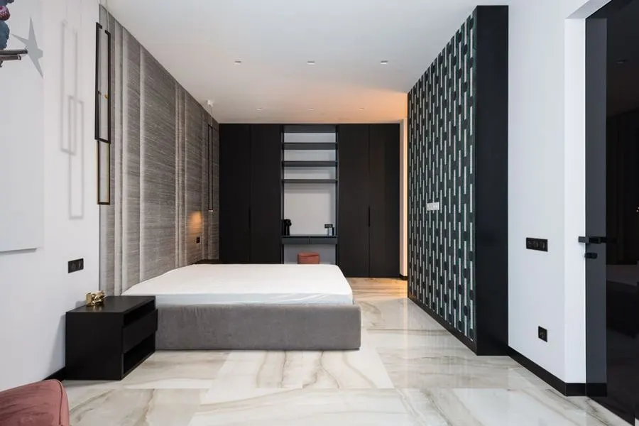 Minimal bedroom with large pale marble-pattern floor tiles
